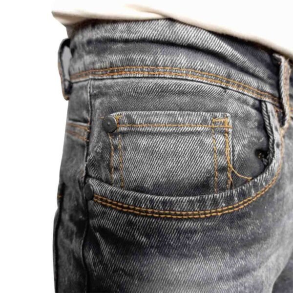 Close-up of the coin pocket closure on PURE & LUXE Acid Wash Black Jeans, worn by a model, highlighting the stylish design and premium craftsmanship.