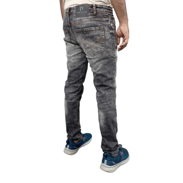 Model wearing PURE & LUXE Acid Wash Black Jeans, showcasing the stylish backside view with a trendy and edgy design.