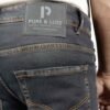 Close-up of the right back pocket and leather patch on PURE & LUXE Classic Black Slim Fit Jeans, highlighting the premium craftsmanship and stylish details.