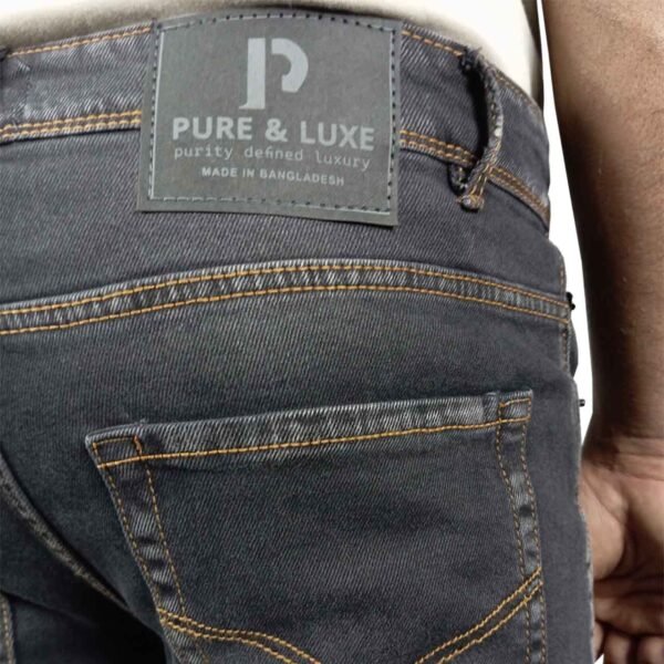 Close-up of the right back pocket and leather patch on PURE & LUXE Classic Black Slim Fit Jeans, highlighting the premium craftsmanship and stylish details.