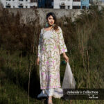 Model wearing an ivory embroidered muslin-silk 3-piece suit with pink and green floral patterns, part of Jubaida’s Collection by Pure & Luxe, standing in a natural outdoor setting.