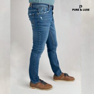 Man wearing Hard Grind Indigo Slim Fit Jeans by Pure & Luxe – right leg view