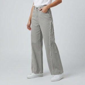 Female model wearing PURE & LUXE Ash Grey Frayed panel Baggy fit Jeans featuring vertical raw-edge detailing and a relaxed wide-leg silhouette.